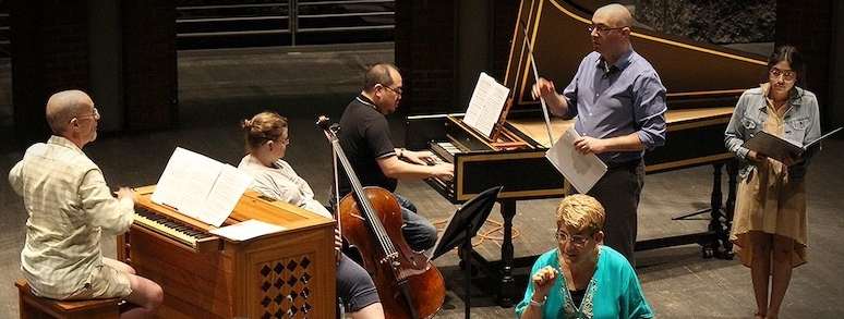 Teachers and college aged students rehearse on stage during the baroque collective course