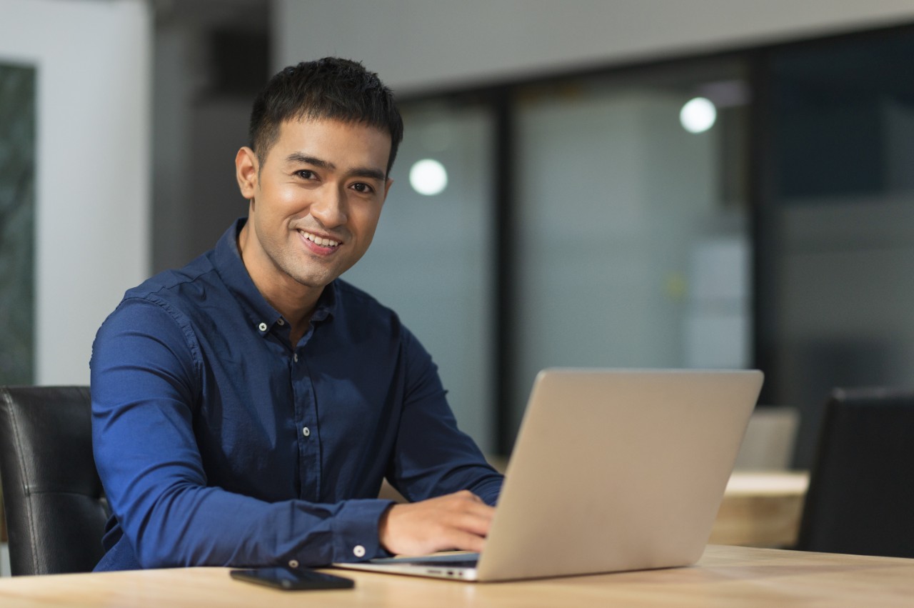 Young asian businessman working with laptop in office. Young asian businessman working with laptop in office.